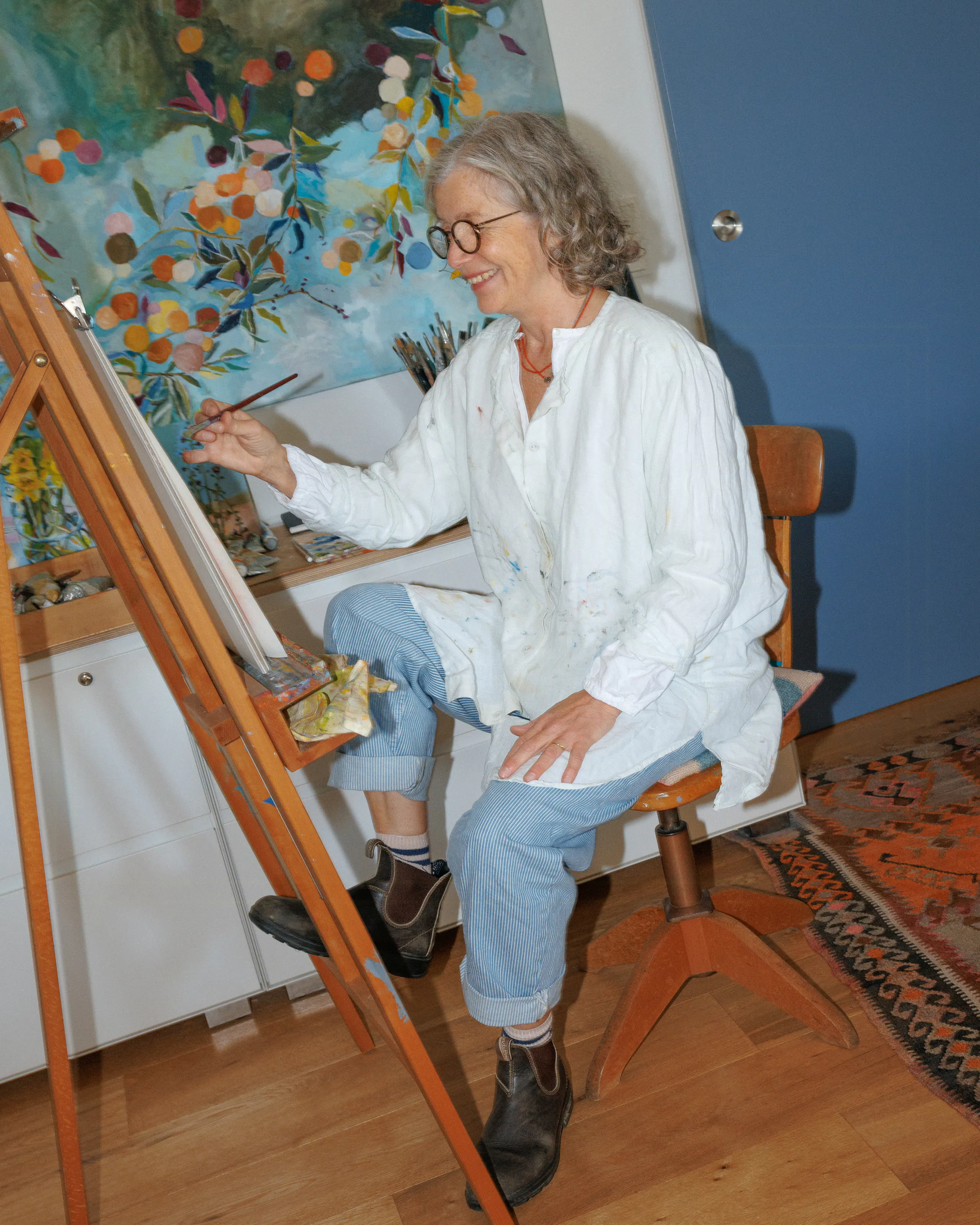 Patricia painting at an easel